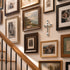 Wall with various framed pictures and a crucifix