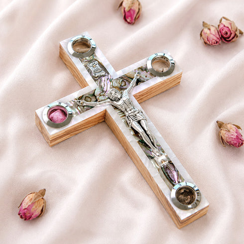 A handcrafted wooden Latin cross with a crucifix, mother of pearl, holy soil, olive leaves, dried flowers, and incense.