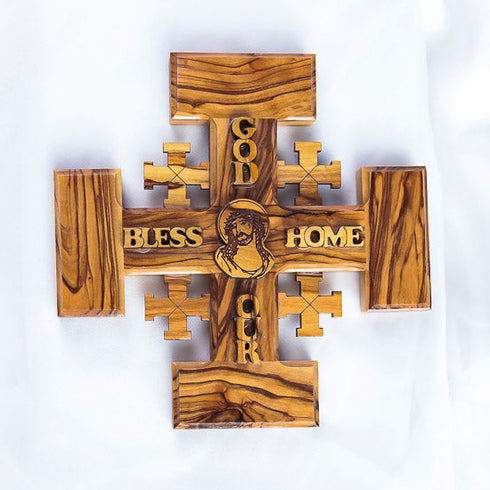 Handmade Olive wood Jerusalem Cross with "God Bless Our Home" and Christs portrait engraved set against a clean white background.