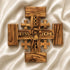 Handmade Olive wood Jerusalem Cross with "God Bless Our Home" and Christs portrait engraved set against a clean white background.