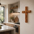 Wooden cross with engraved text on a wall in a kitchen.