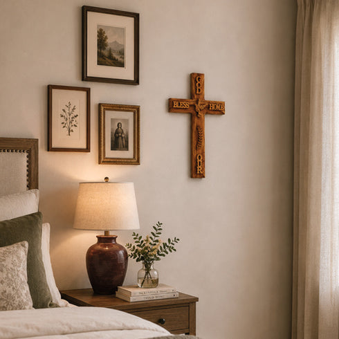 Nursery room with wooden cross, framed pictures, and lamp on a nightstand.