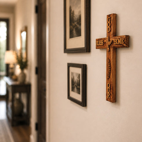 Wooden cross with engraved text on a wall in a home setting