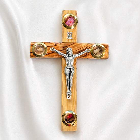 Small olive wood Latin crucifix with Four Elements on a white surface