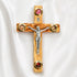 Small olive wood Latin crucifix with Four Elements on a white surface