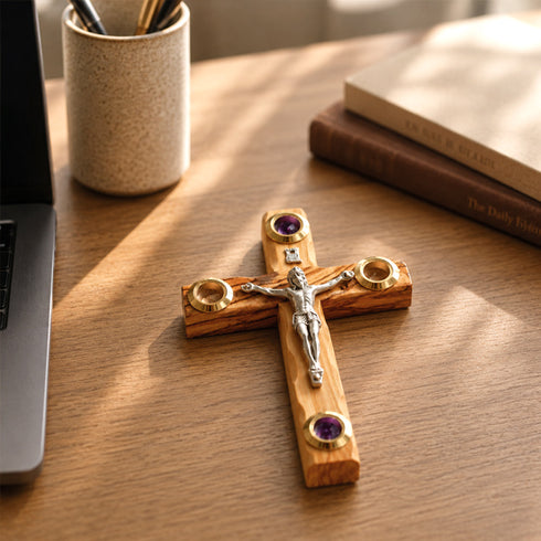 Wooden cross with Jesus Christ figure on a wooden desk