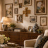 Living room with wooden sideboard, decorative items, and framed pictures on the wall.