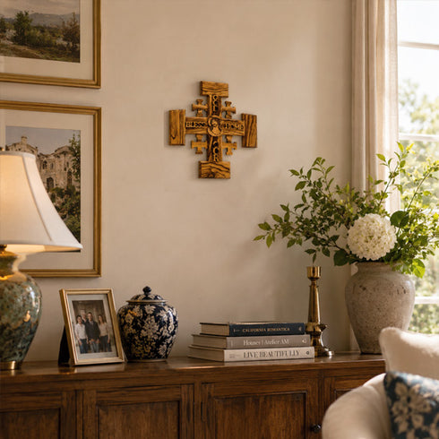 Decorative room interior with a wooden sideboard, lamp, vases, and framed photos.