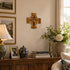 Decorative room interior with a wooden sideboard, lamp, vases, and framed photos.