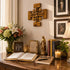 Decorative table with books, candles, flowers, and religious items on a wooden surface.