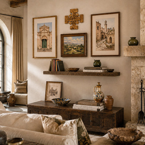 Living room with rustic decor, including a fireplace, shelves with books and vases, and wall art.