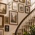 Staircase with framed artwork on the wall