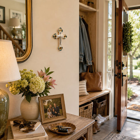 Nook with a lamp, flowers, picture frame, and cross on the wall.