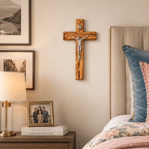 Bedroom with wooden crucifix, lamp, and framed family photo