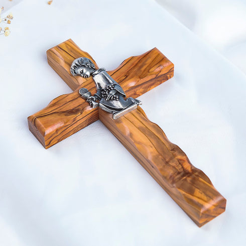 Handcrafted communion olive wood cross with a metallic emblem of a praying boy at its center.