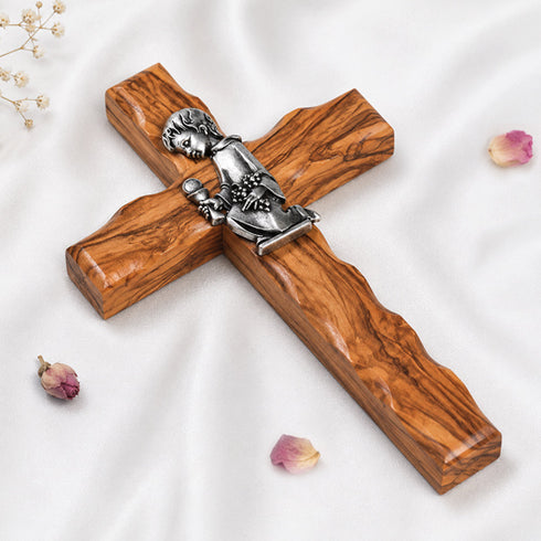 Handcrafted communion olive wood cross with a metallic emblem of a praying boy at its center.