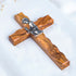 Handcrafted communion olive wood cross with a metallic emblem of a praying boy at its center.