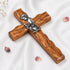 Handcrafted communion olive wood cross with a metallic emblem of a praying boy at its center.