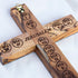Close-up of latin cross handmade of olive wood with Stations of Cross and Jerusalem engraved on the back.
