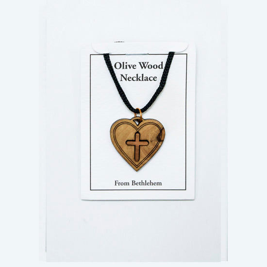 Olive wood heart-shaped necklace with cross on a white card, displayed on a white background.