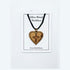 Olive wood heart-shaped necklace with cross on a white card, displayed on a white background.