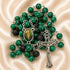 A green and black rosary with a silver-tone crucifix and a central medallion, on a satin fabric background.