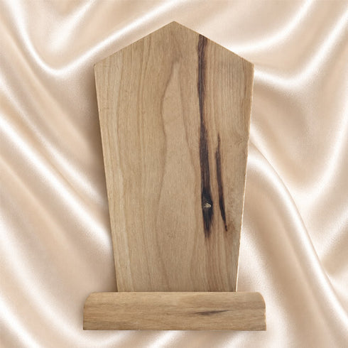 Back view of a Holy Family olive wood plaque showing the natural wood grain and bark edge