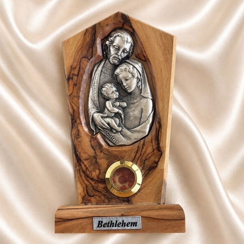 Holy Family olive wood plaque with natural grain and bark edge, shown upright against a neutral background