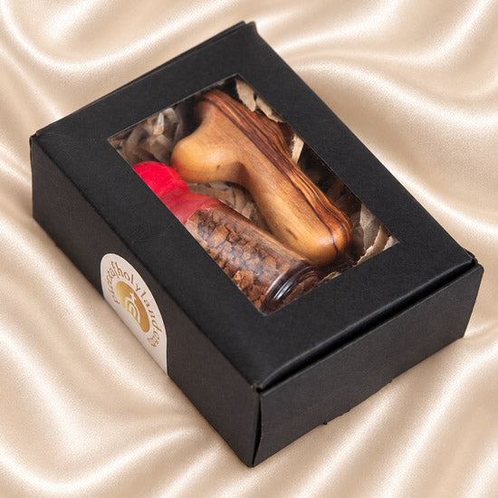 Holy Land soil vial paired with an olive wood comfort cross in a compact Christian gift set