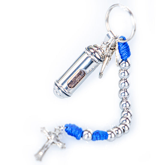 Image of a small blue and iron St. Benedict keychain rosary with a vial of Holy Soil from the Holy Land, against white background.