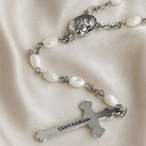 White pearl rosary with silver chain links, oval medallion, and metal crucifix