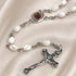White pearl rosary with round Jerusalem-style centerpiece and metal crucifix pendant