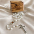 White pearl rosary with oval medallion and metal crucifix, olive wood box behind