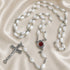 White pearl rosary set with bead strands, round centerpiece, and metal crucifix