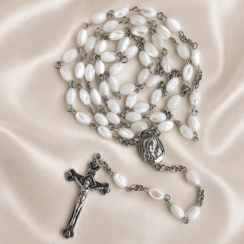 White pearl rosary with silver chain, oval medallion, and metal crucifix cross