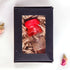 Product image of a Holy Water vial from the Holy Land with a red cap, elegantly presented in a black box.