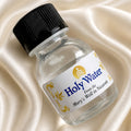 A small bottle with a black ribbed cap and a white label reading 'Holy Water From the Mary's Well in Nazareth,'