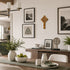 Dining room with a wooden table, chairs, and decorative elements on the wall.