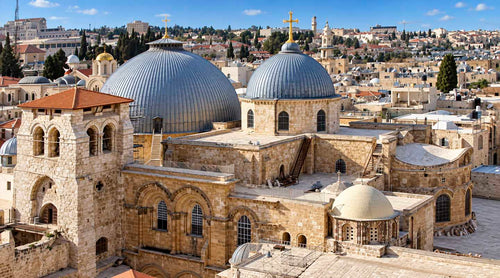 Arial view of the blue cupolas crowned with a golden cross atop the Church of the Holy Sepulchre.