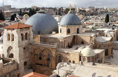 Arial view of the blue cupolas crowned with a golden cross atop the Church of the Holy Sepulchre.