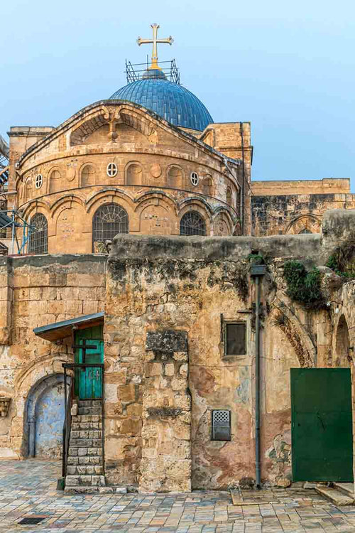 Rooftop and the blue cupola with a golden iron cross of the Church of the Holy Sepulchre.