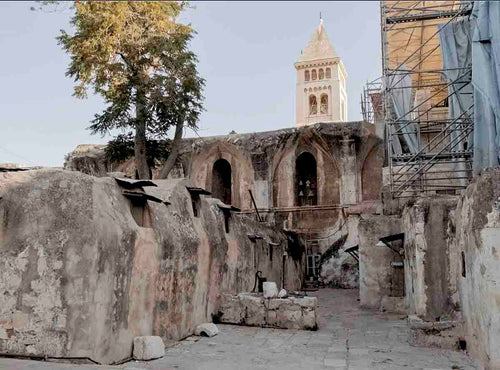 Rooftop of the Church of the Holy Sepulchre in Jerusalem with blue sky.