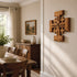 Dining room with wooden cross wall art, table, and chairs.
