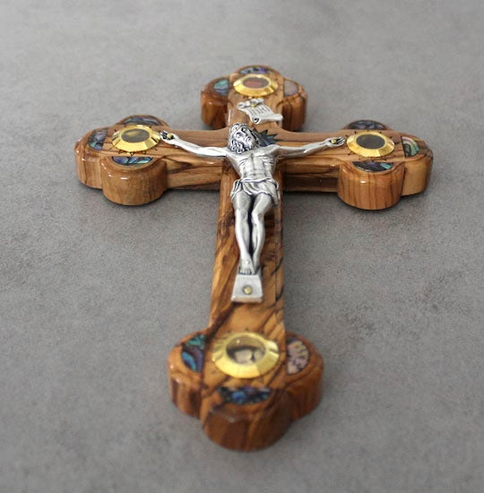 Olive Wood Budded Cross with Four Holy Elements laying on a grey background