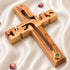 Wooden cross with a gold accent on a white fabric background
