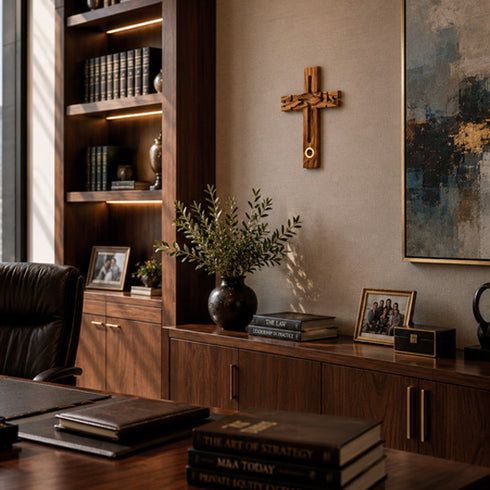 Decorative interior with wooden bookshelf, cross, and books on a table.