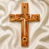 A Jesus-shaped olive wood cross with holy soil from Jerusalem, featuring detailed carvings and an embedded ring for holding holy soil.