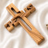 Wooden cross on a white fabric background