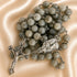 A rosary with gray stone beads and silver-tone metal links, featuring a crucifix and centerpiece, on a fabric background.
