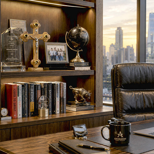 Modern office desk with cross on a bookshelf witrh pictures, mug, and cityscape view